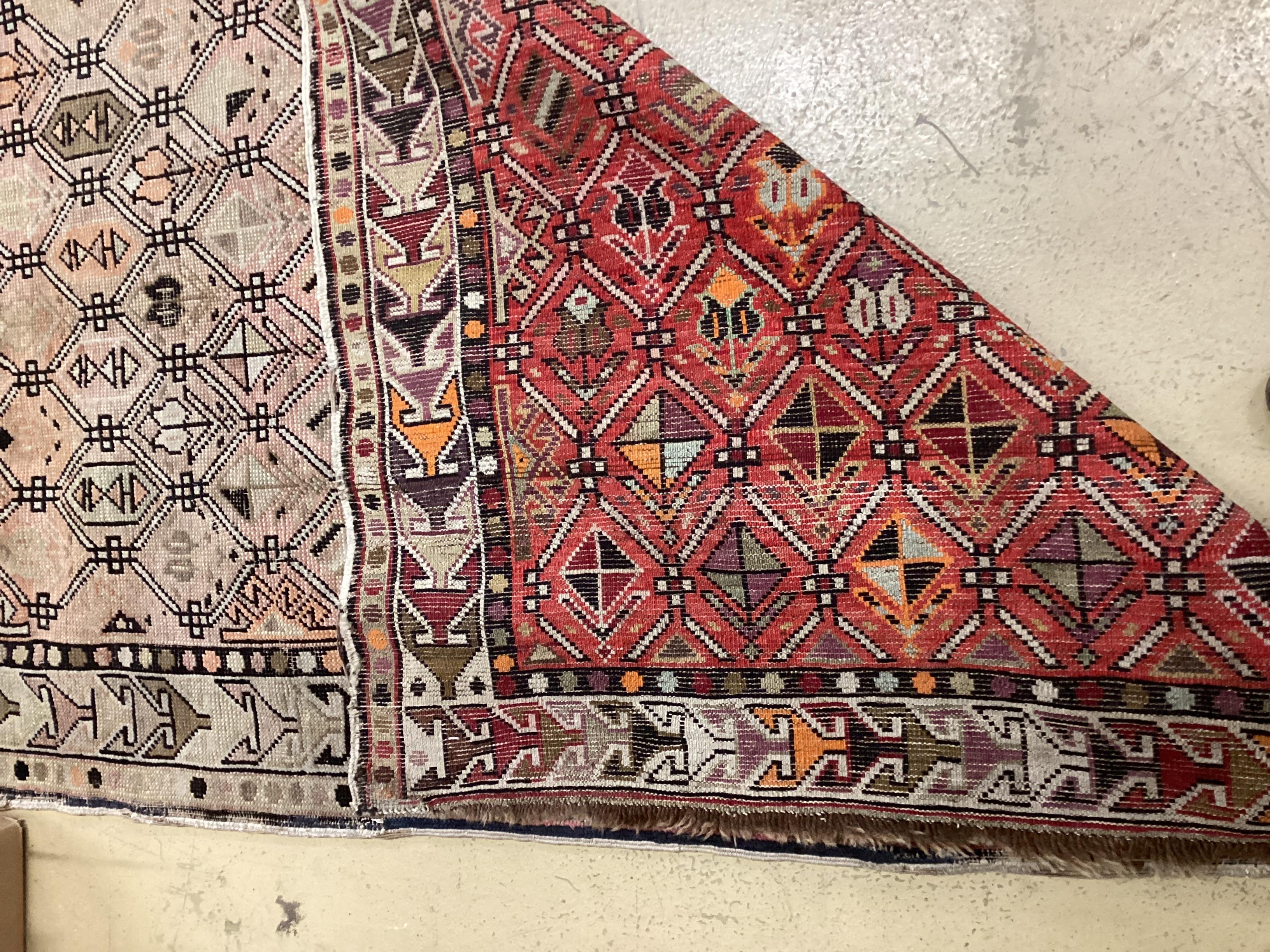 An antique Turkish faded red ground rug, 158 x 98cm
